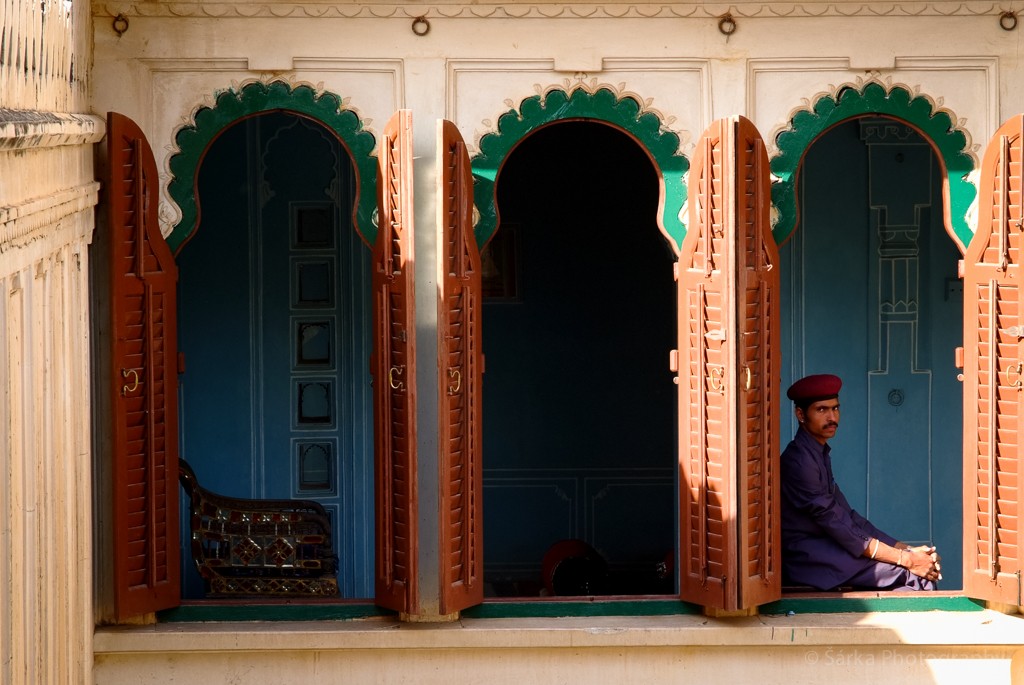 Man sitting in a window at Udaipur Palace India