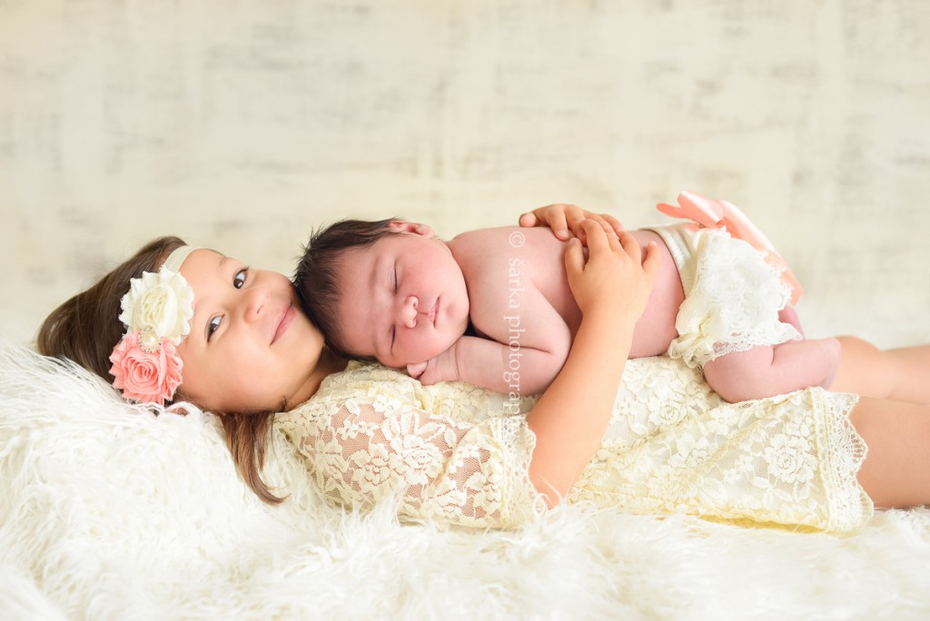 newborn baby girl sleeping on her older sister photographed by San Francisco and Marin Bay area newborn photographer Sarka Photography