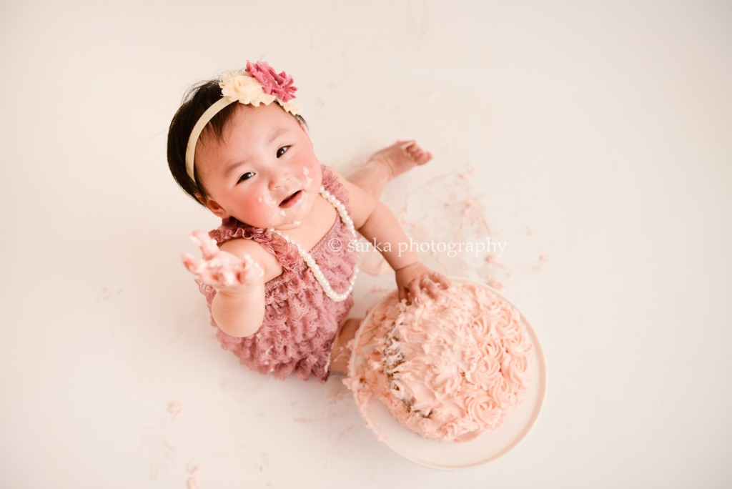one year old baby girl with a cake photographed by San Francisco Bay Area photographer Sarka Photography