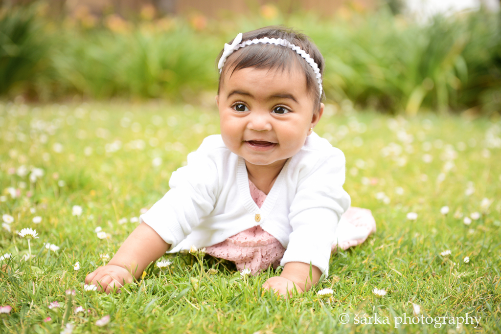 six months old baby girl sitting in  the park photographed by San Francisco baby photographer Sarka Photography