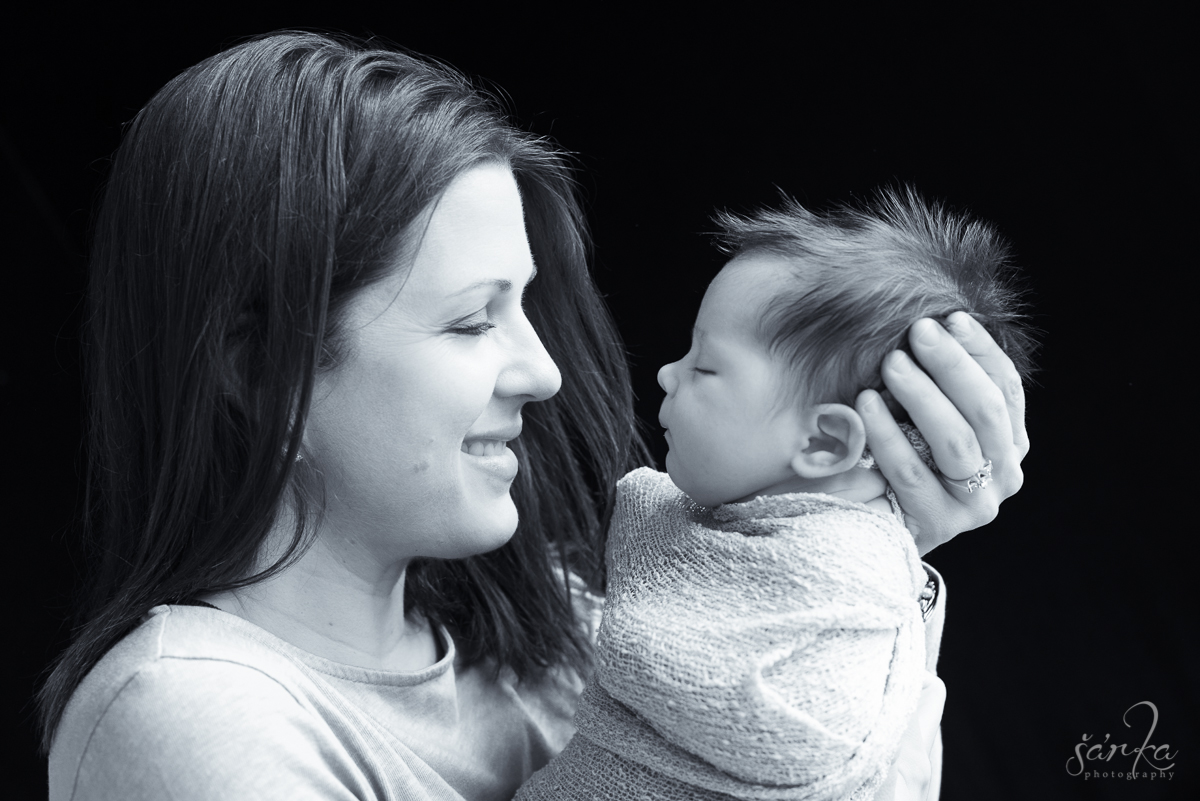new mom holding her newborn baby girl photographed by San Francisco Bay Area newborn and baby photographer Sarka Photography