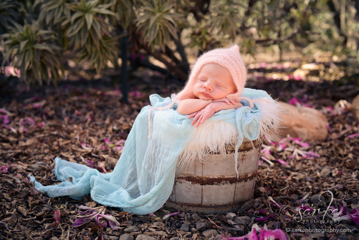 newborn baby girl sleeping in a vintage wood bucket photographed by Santa Barbara newborn photographer Sarka Photography Studio