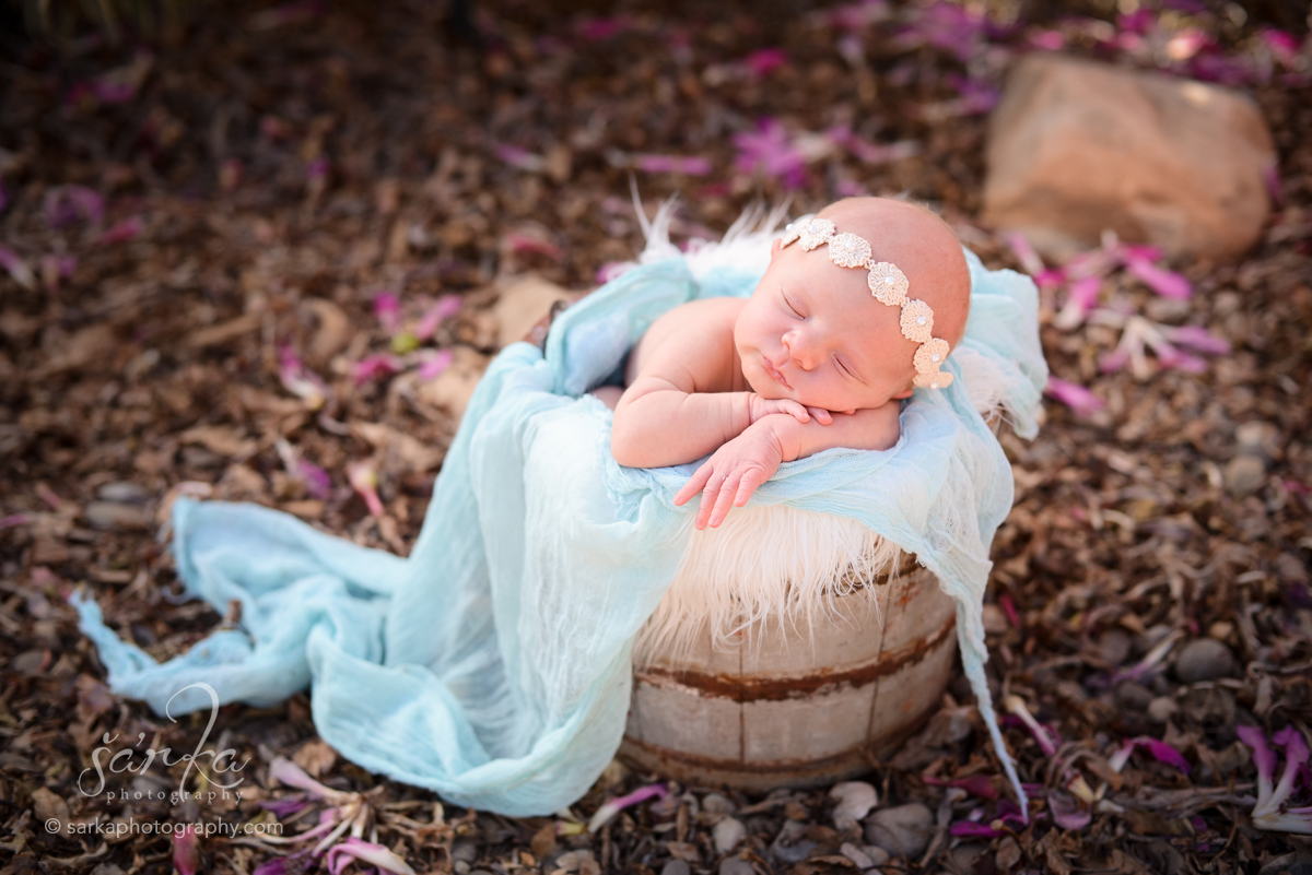 newborn baby girl sleeping in a vintage wood bucket photographed by Santa Barbara newborn photographer Sarka Photography Studio