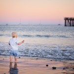 Santa Barbara baby boy standing on the beach at sunset photographed by Santa Barbara and San Francisco bay area baby photographer Sarka Photography