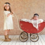 newborn baby girl sleeping in vintage carriage with her older sister photographed by San Francisco Bay Area and Santa Barbara baby photographer Sarka Photography
