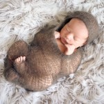 newborn baby girl sleeping in hand knitted wrap photographed by San Francisco Bay Area and Santa Barbara baby photographer Sarka Photography