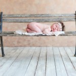newborn baby girl sleeping on a vintage bench photographed by San Francisco Bay Area and Santa Barbara baby photographer Sarka Photography