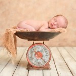 newborn baby boy sleeping on a vintage scale photographed by San Francisco Bay Area and Santa Barbara baby photographer Sarka Photography