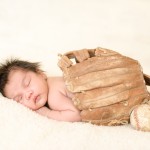 newborn baby boy sleeping under a vintage baseball glove photographed by San Francisco Bay Area and Santa Barbara baby photographer Sarka Photography