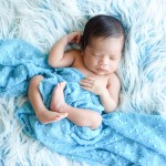 newborn baby boy sleeping on a blue fuzzy blanket photographed by San Francisco Bay Area and Santa Barbara baby photographer Sarka Photography