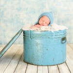 newborn baby boy sleeping in a vintage blue metal tin photographed by San Francisco Bay Area and Santa Barbara baby photographer Sarka Photography