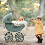 newborn baby sleeping in vintage carriage with her older sister photographed by San Francisco Bay Area and Santa Barbara baby photographer Sarka Photography