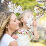 mom and daughter smelling tree blossoms photographed by Santa Barbara and San Francisco Bay area photographer Sarka Photography