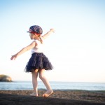 young girl walking on a wood log on the beach photographed by Santa Barbara and San Francisco Bay area photographer Sarka Photography