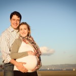 young expecting couple standing at the beach photographed by Santa Barbara and San Francisco Bay area photographer Sarka Photography