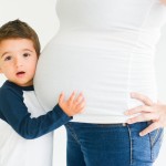 young boy listening to his moms pregnant belly photographed by Santa Barbara and San Francisco Bay area photographer Sarka Photography