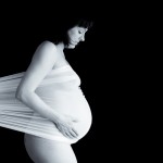 pregnant woman wrapped in a fabric pregnant woman showing off her belly photographed by Santa Barbara and San Francisco Bay area photographer Sarka Photography