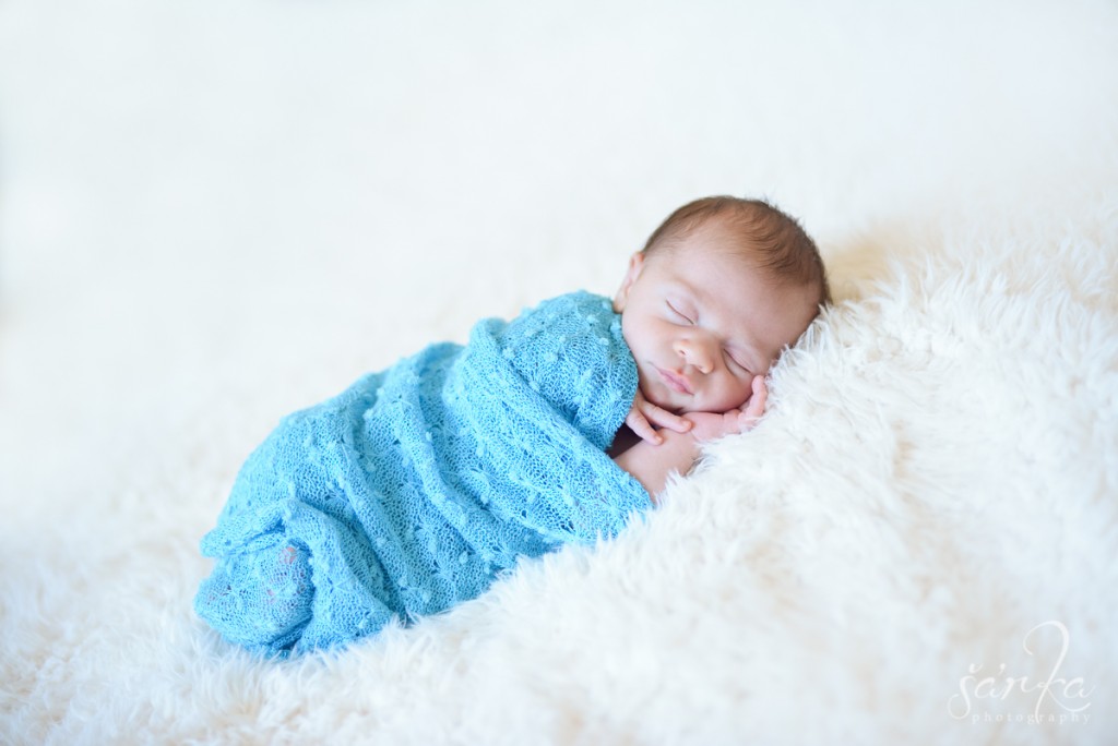 newborn baby boy sleeping on a furry blanket photographed by Santa Barbara newborn and baby photographer Sarka Photography