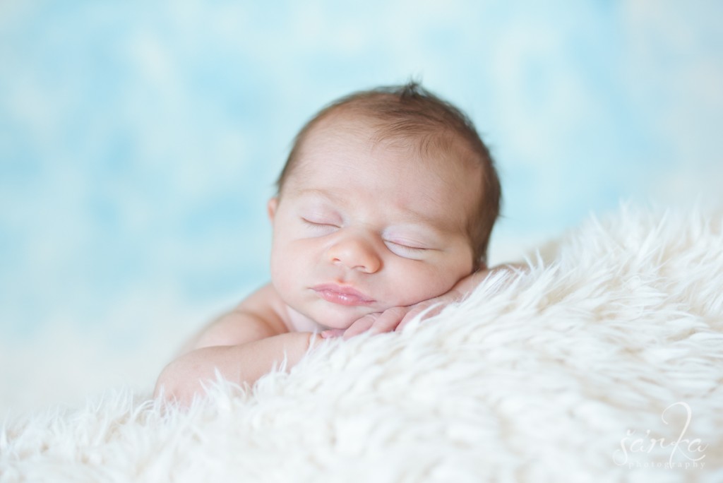 newborn baby boy sleeping on a furry blanket photographed by Santa Barbara newborn and baby photographer Sarka Photography