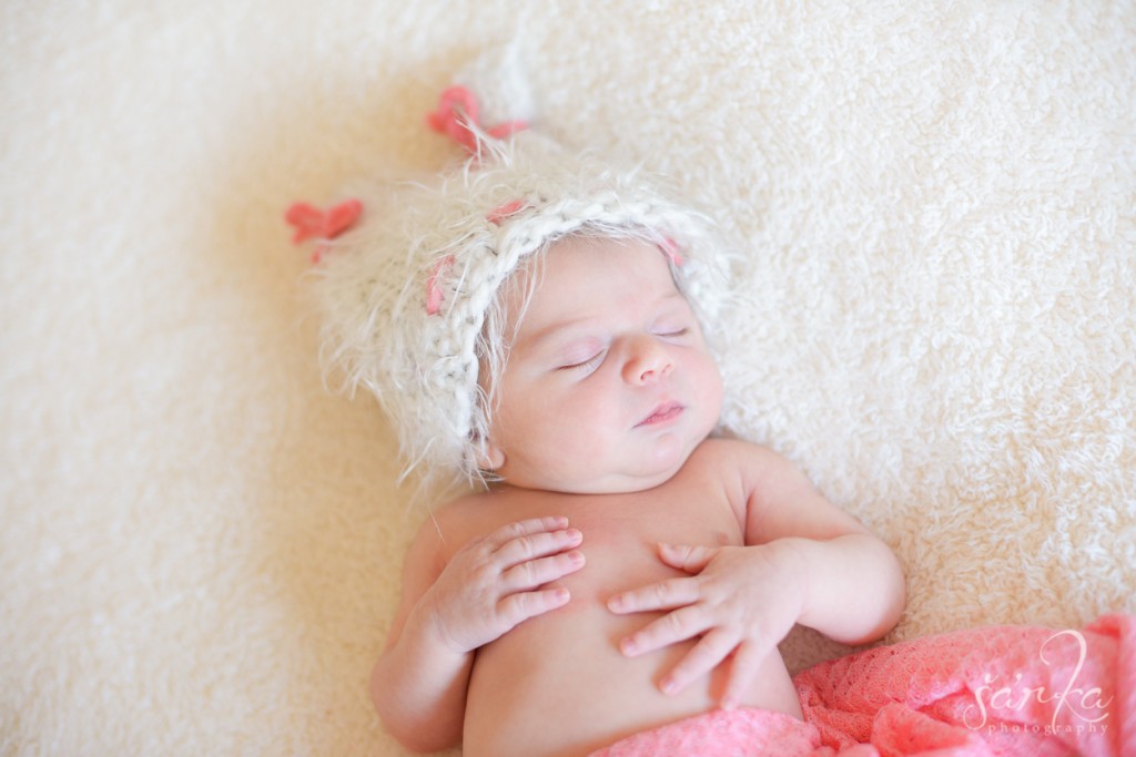newborn baby girl sleeping in a hand knitted hat photographed by San Francisco Bay area baby photographer Sarka photography