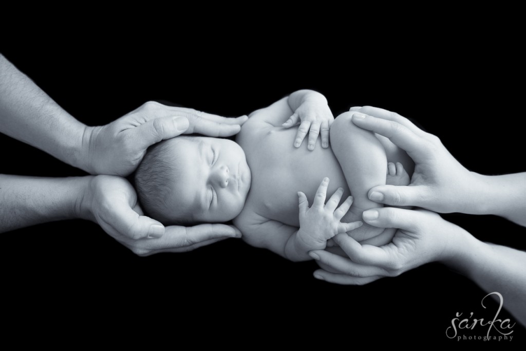 newborn baby girl sleeping in her parents hands photographed by San Francisco Bay area baby photographer Sarka photography