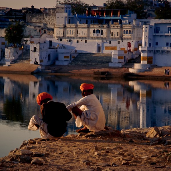 men sitting at sunset in Pushkar India by Sarka Photography