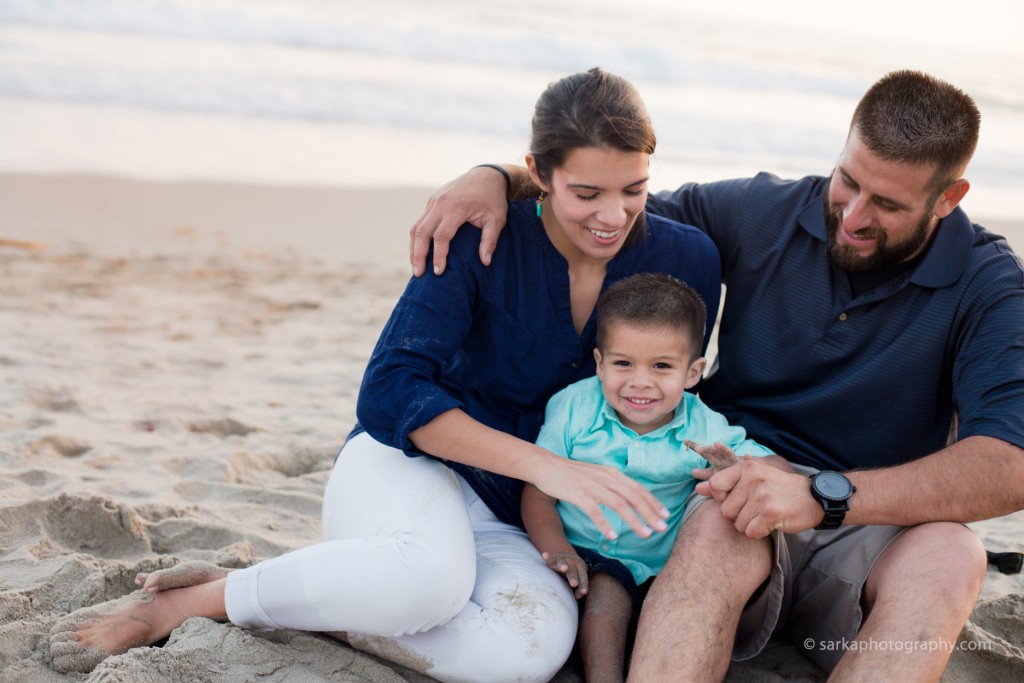 young family snuggling at sunset on the beach photographed by Santa Barbara children photographer Sarka Photography