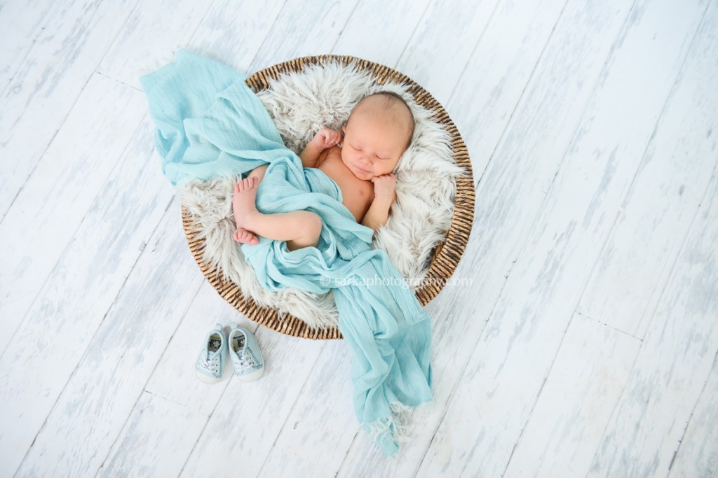 newborn baby boy sleeping in a basket photographed by San Francisco and Santa Barbara baby photographer Sarka Photography