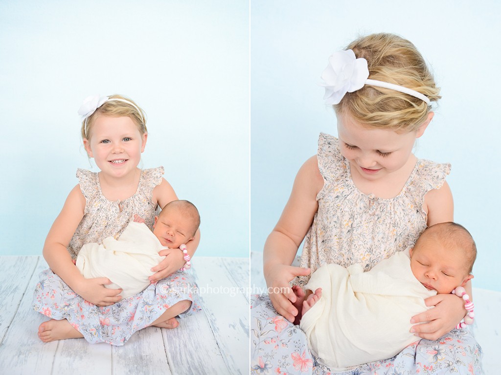 toddler girl holding her newborn brother photographed by San Francisco and Santa Barbara baby photographer Sarka Photography