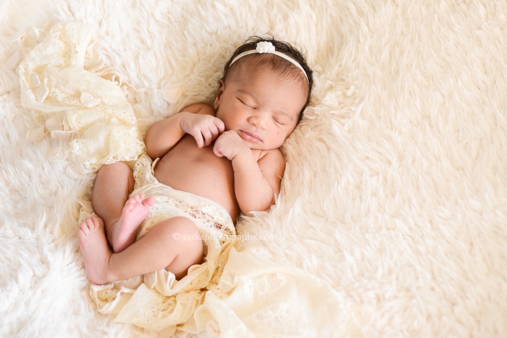 newborn baby girl sleeping wrapped in a lace scarf photographed by San Francisco and Santa Barbara baby photographer Sarka photography