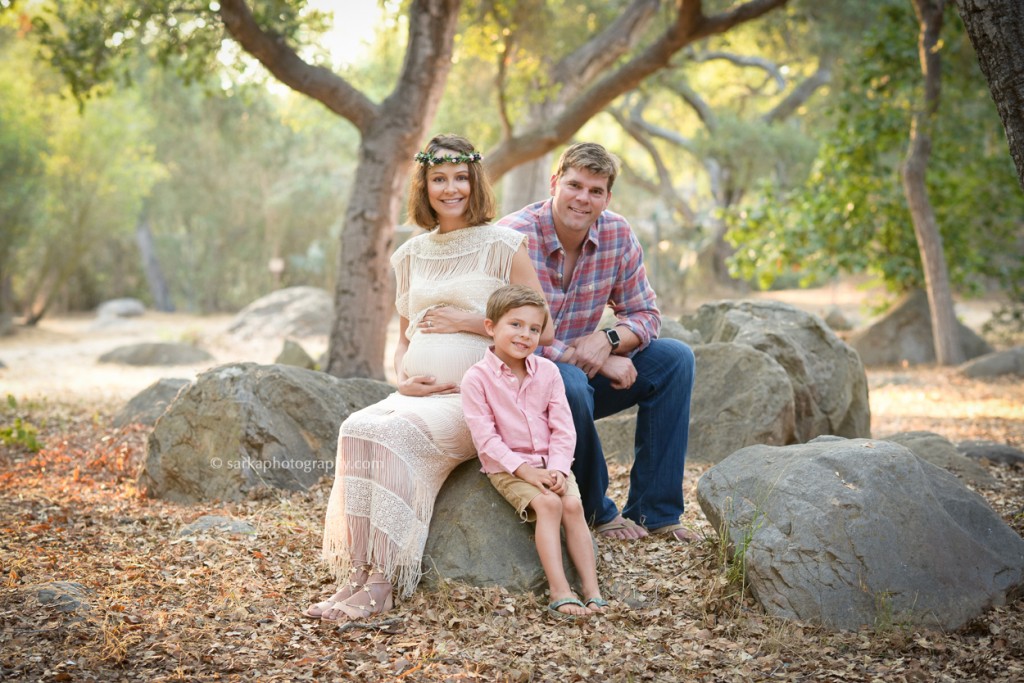 young family sitting on rocks in an oak tree park photographed by Santa Barbara family photographer Sarka Photography