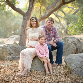 young family sitting on rocks in an oak tree park photographed by Santa Barbara family photographer Sarka Photography