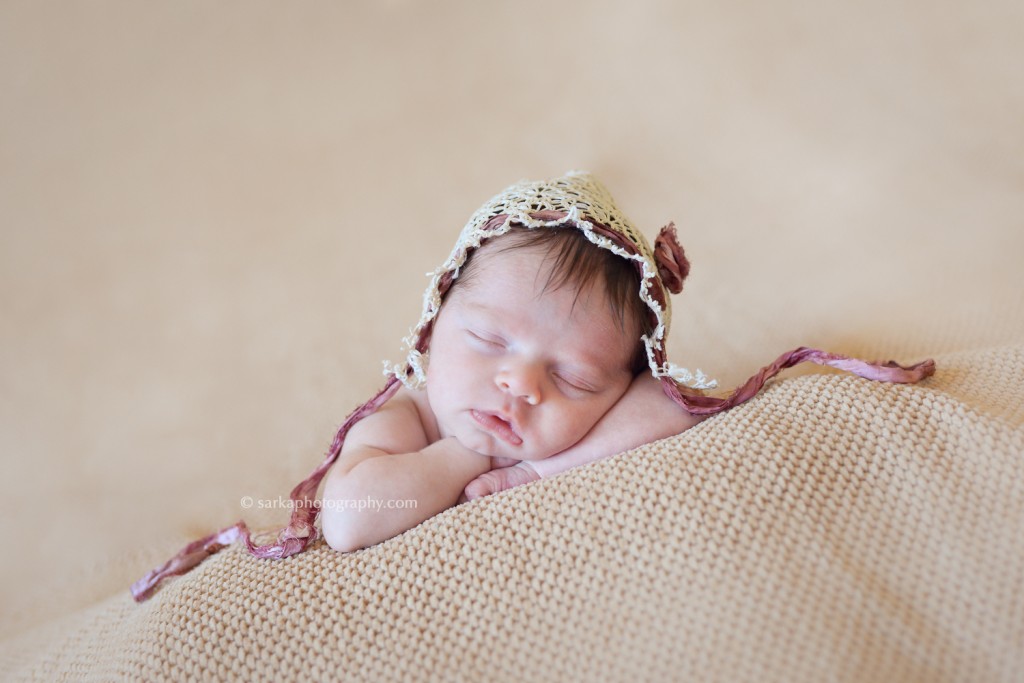 newborn baby girl sleeping wearing a handmade lace bonnet photographed by Santa Barbara newborn photographer Sarka photography