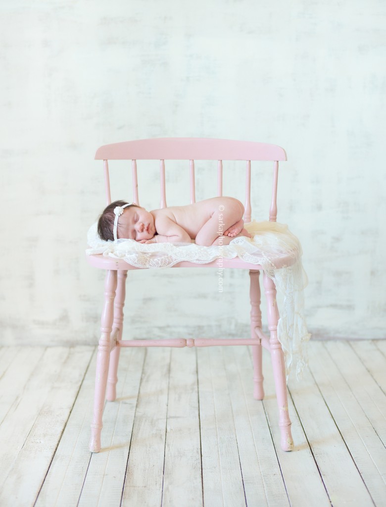 newborn baby girl sleeping on a vintage pink chair photographed by Santa Barbara newborn photographer Sarka photography
