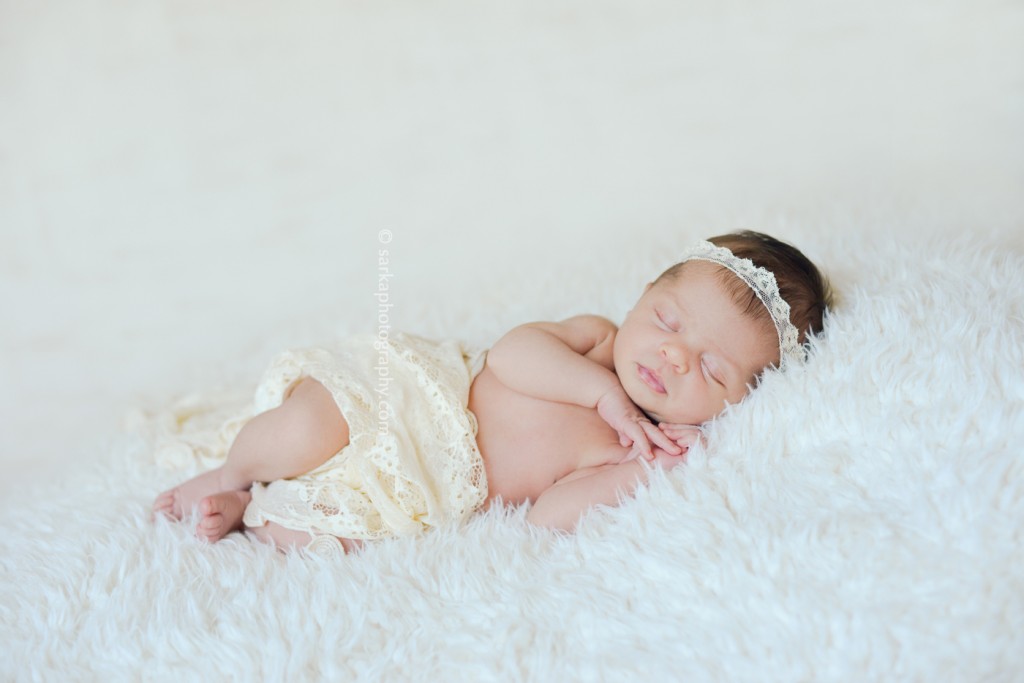 newborn baby girl sleeping on a soft fuzzy blanket photographed by San Francisco Bay area and Santa Barbara baby photographer Sarka Photography