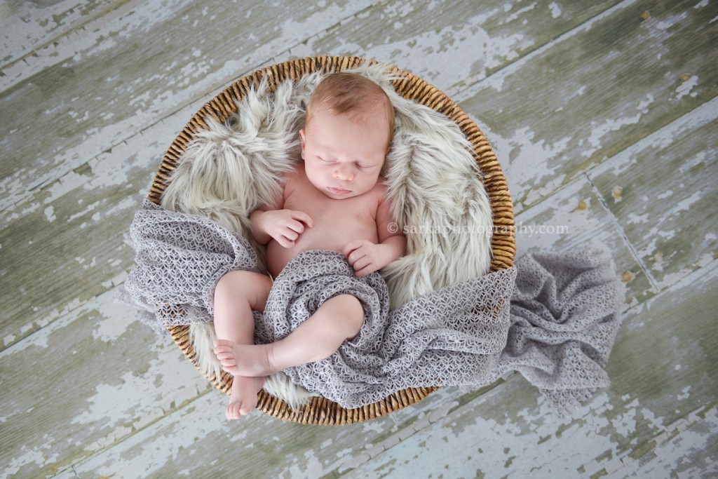 newborn baby boy sleeping in basket photographed by Marin county newborn photographer