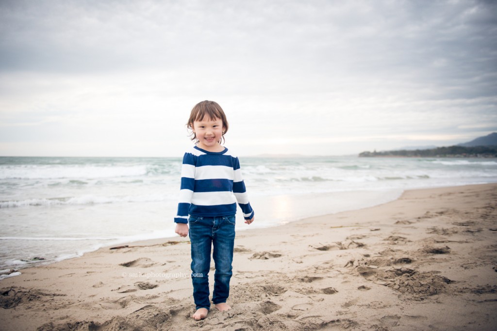 little girl in a striped shirt on the beach photographed by Santa Barbara children and family photographer by Sarka Photography