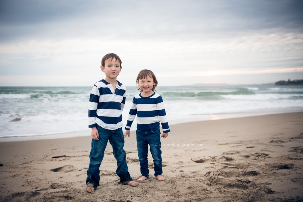 siblings playing on the beach in Santa Barbara during family and children photo session by Sarka Photography