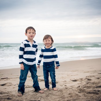 siblings playing on the beach in Santa Barbara during family and children photo session by Sarka Photography