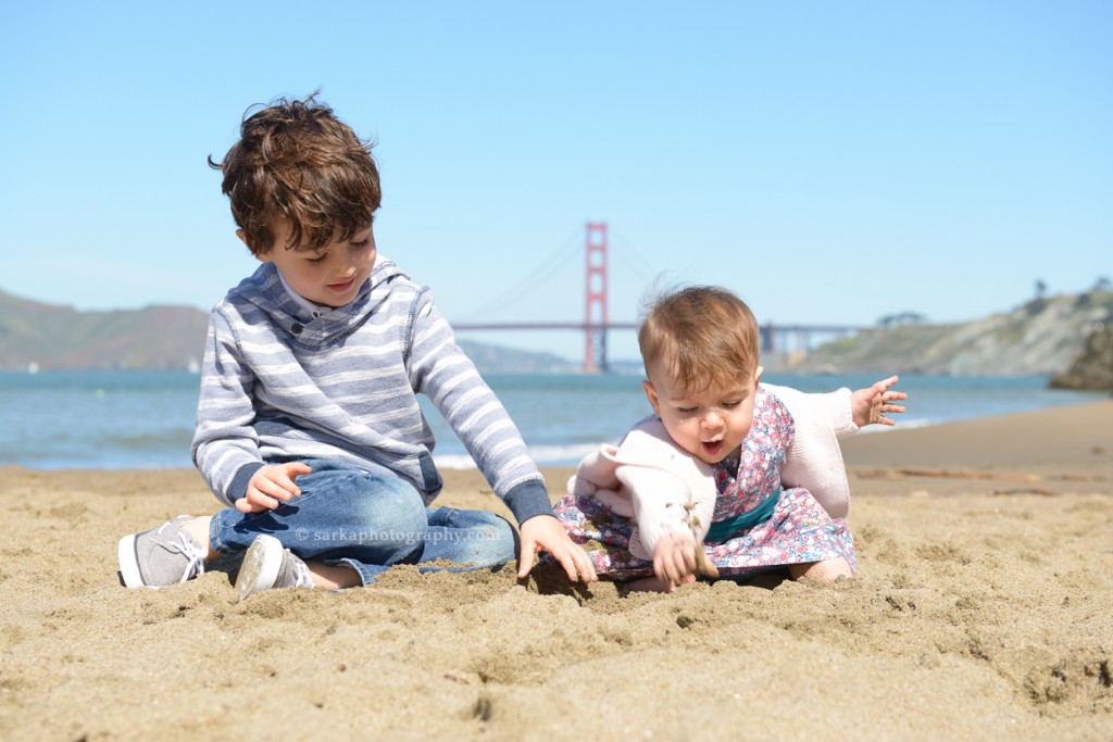 brother and sister playing on the beach in San Francisco photographed by San Francisco and Santa Barbara baby photographer Sarka 