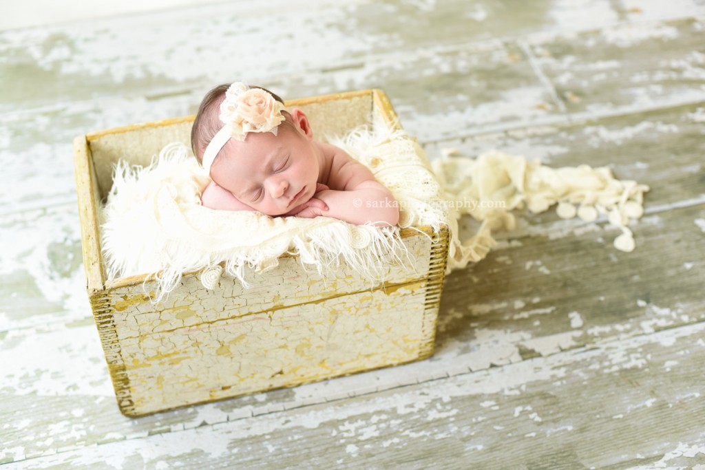 newborn baby girl sleeping in a vintage yellow wood box photographed by San Francisco and Santa Barbara newborn baby photographer Sarka photography