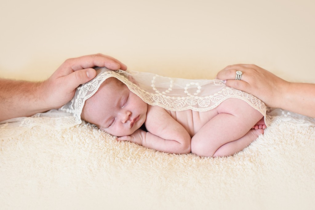 parents gently holding hands on their newborn baby girl sleeping photographed by Santa Barbara Montecito newborn and baby photographer Sarka photography