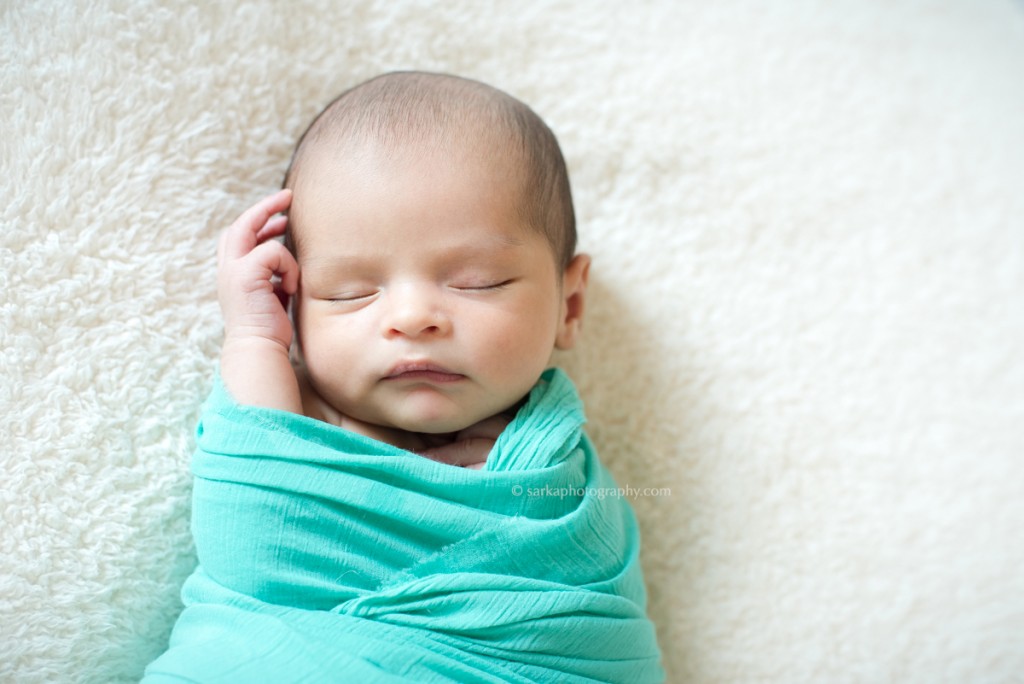 newborn baby boy swaddled in a turquoise fabric by Santa Barbara Montecito newborn photographer sarkaphotography