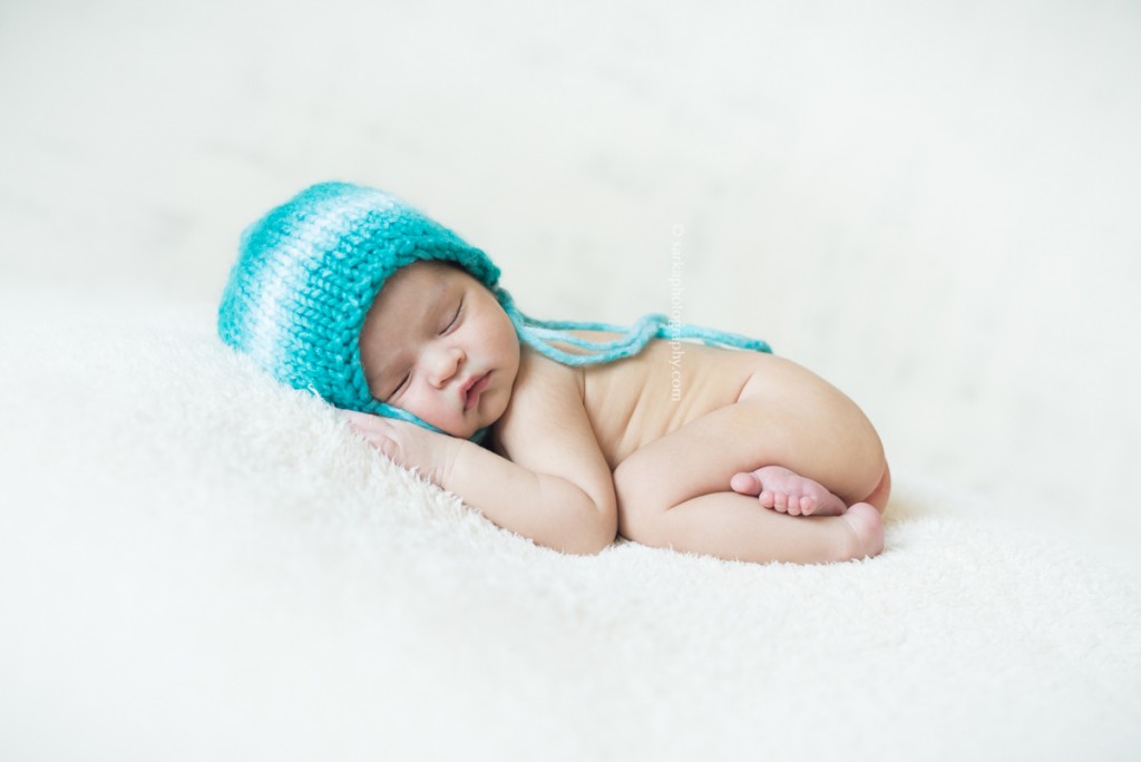 newborn baby boy sleeping in a hand knitted hat by Santa Barbara Montecito newborn photographer sarkaphotography