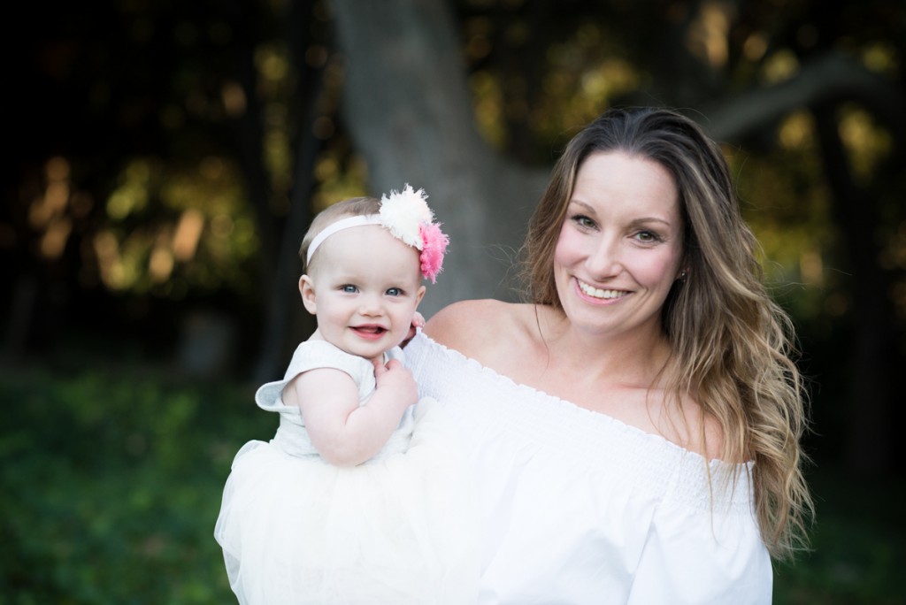 beautiful mom holding her 9month baby girl during her baby photo session in East Bay photographed by sarkaphotography