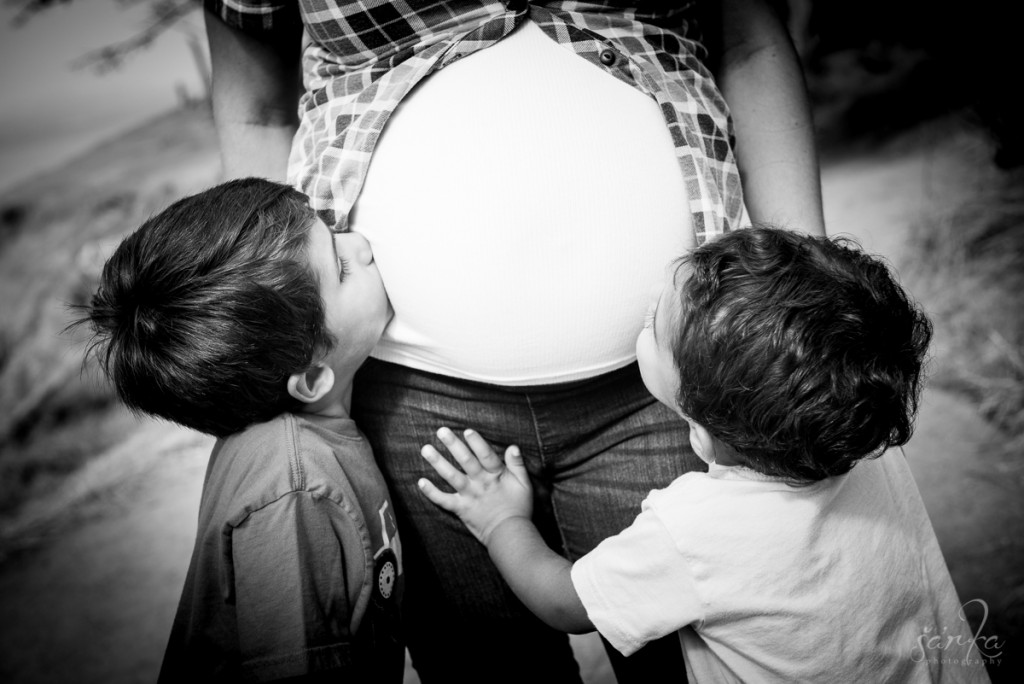 siblings kissing pregnant belly by san francisco bay area baby and family photographer sarkaphotography