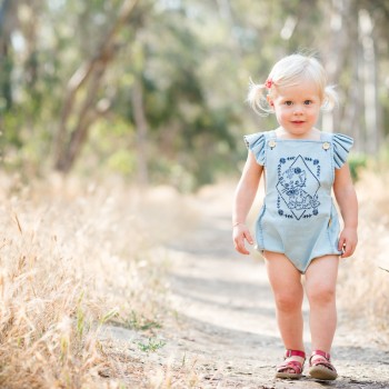 toddler girl wearing a romper suit on a woodsy path photographed by santa barbara montecito carpinteria children photographer sarkaphotography