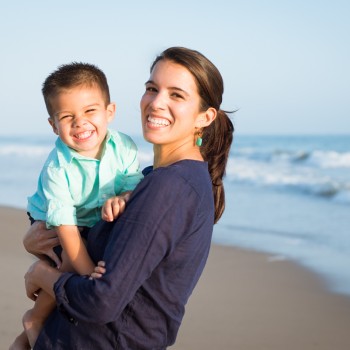 young mom holding his toddler boy during a family photo session in Carpinteria by sarkaphotography