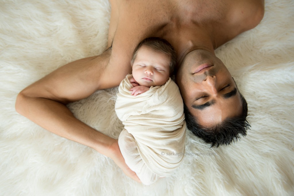 young dad snuggling with his newborn son photographed by sarka photography