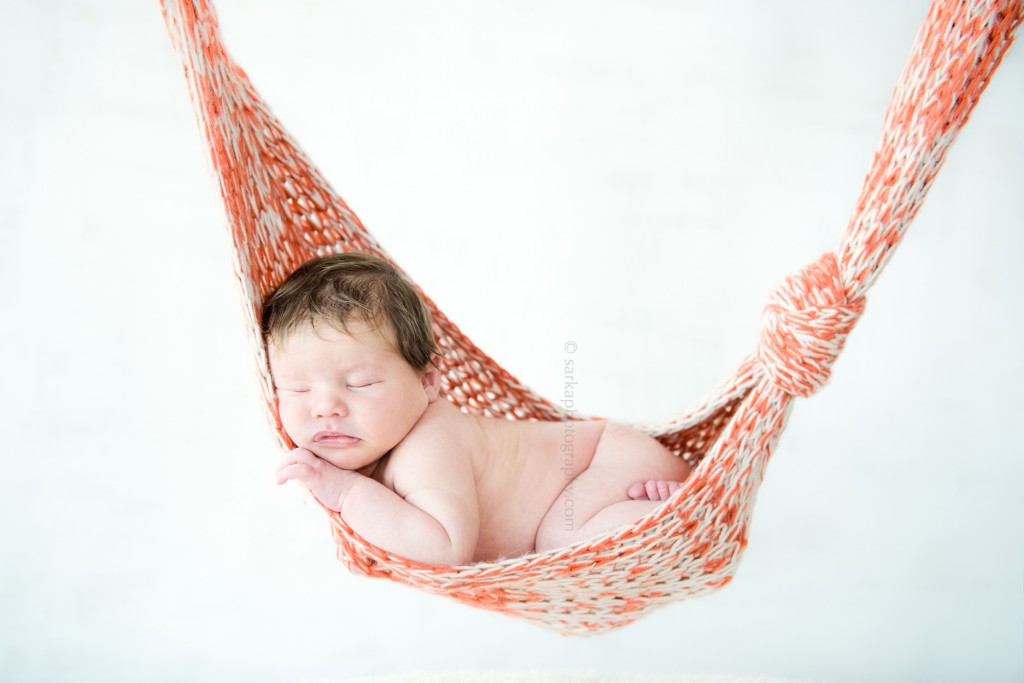 newborn boy sleeping in a knitted hammock by san francisco and santa barbara baby photographer
